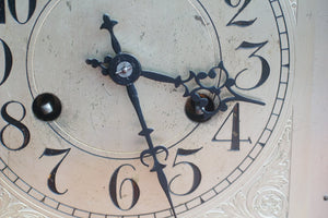 A mahogany mantle clock with the most fabulously engraved face