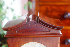 A mahogany mantle clock with the most fabulously engraved face