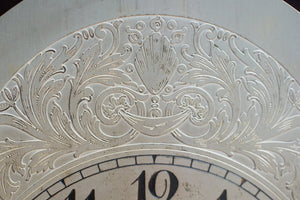 A mahogany mantle clock with the most fabulously engraved face