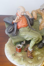 Load image into Gallery viewer, A splendid large porcelain Capodimonte sculpture representing two drunken tramps sat on a bench